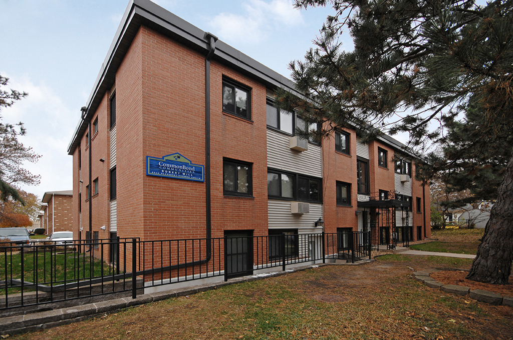 a brick building with a blue sign on the side of it